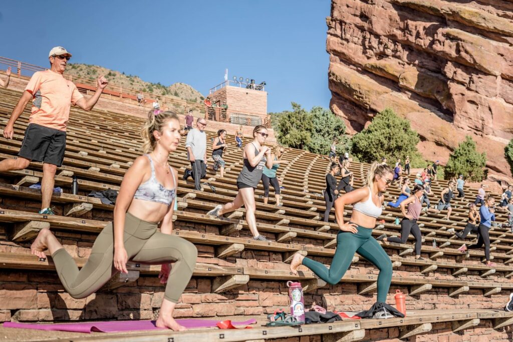 people exercise in green space in Red Rocks